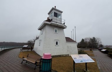 The historic white Fort Point Lighthouse is seen on an overcast day in Nova Scotia