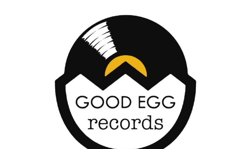 The black and white and yellow Good Egg Records Logo with half Vinyl, half Egg