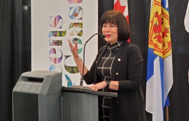 A woman speaks at a podium