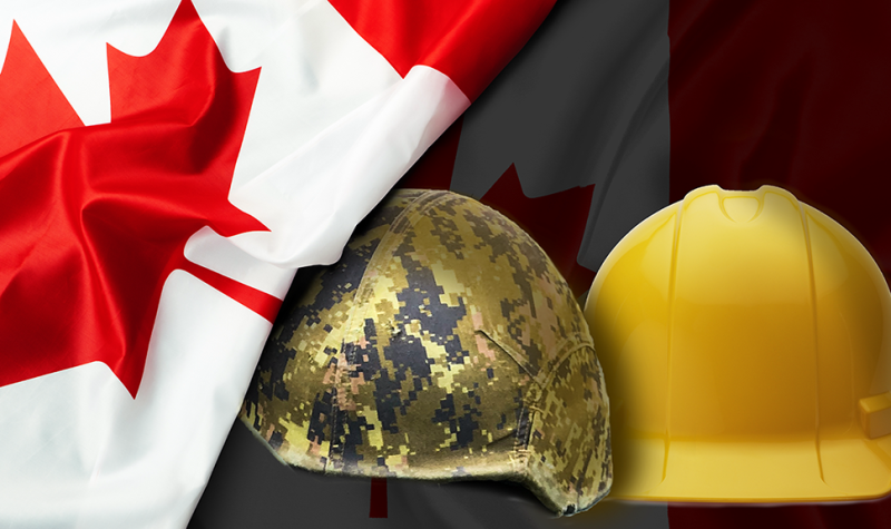 A Canada flag is seen draped over a soldier's helmet and a yellow hardhat, sitting side-by-side.