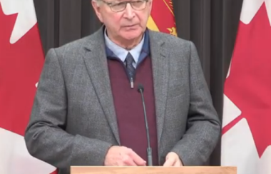 Premier Blaine Higgs speaking at a podium during a press conference in late November.