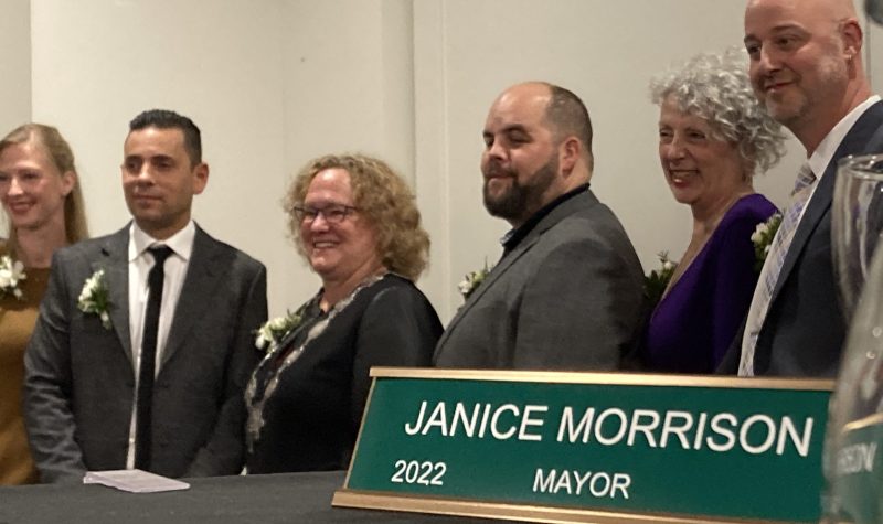 A group of Nelson city council posing for this photo on November 8. The group is standing indoors against a white wall, with mayor janice Morrison in the middle