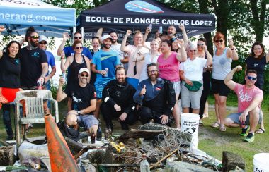 Pictured are the volunteers, members of RBL, and divers from Faisons notre part standing behind a pile of trash that they pulled from the lake.