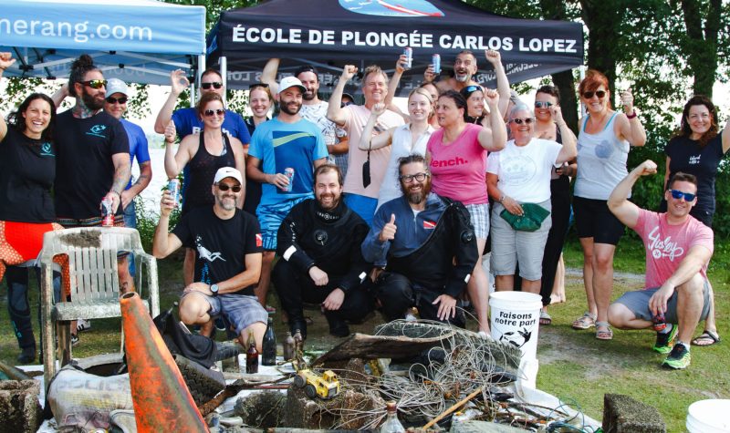 Pictured are the volunteers, members of RBL, and divers from Faisons notre part standing behind a pile of trash that they pulled from the lake.
