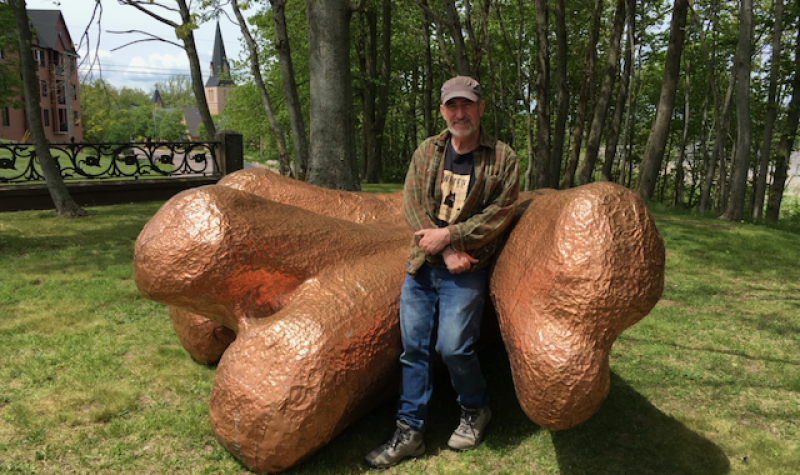 Artist Paul Griffin stands with his work, Elegy for an Elm, which recently appeared on the grounds of Cranewood on Main. Photo: Erica Butler