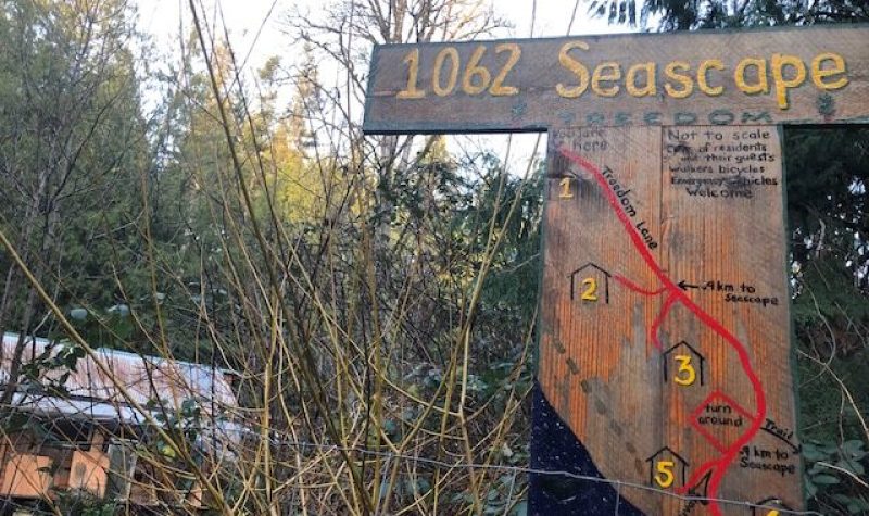 Sign signaling entrance to Treedom land partnership, with map of walking trails.