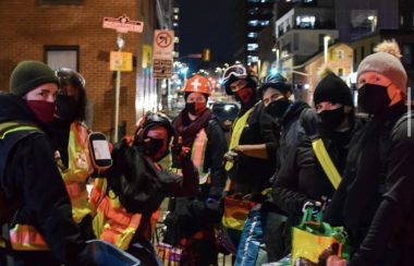 Ottawa Street Medics deliver food in downtown Ottawa at night.