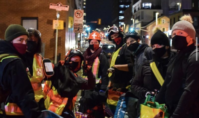 Ottawa Street Medics deliver food in downtown Ottawa at night.