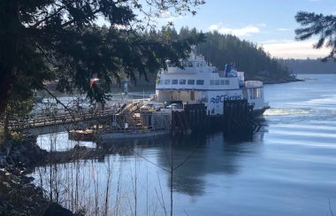 A blue and white BC Ferries vessel docks in Whaletown on Cortes Island