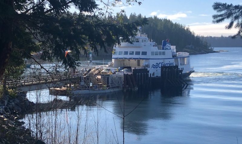 A blue and white BC Ferries vessel docks in Whaletown on Cortes Island