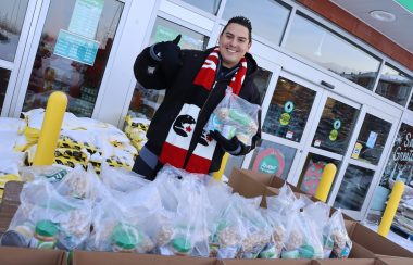 Can Man Dan standing over a big food bank donation in front of Southbrook Sobeys. Weather conditions are clear.