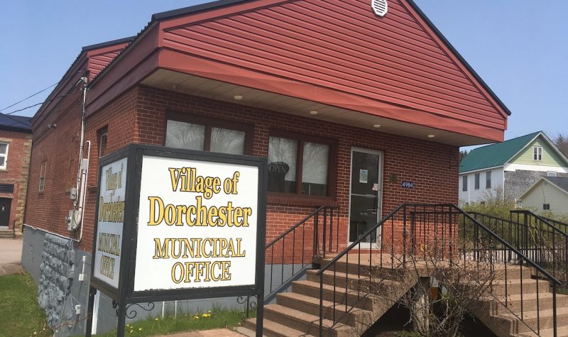 A red building with Village of Dorchester Municipal Office sign