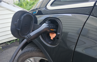 An electric vehicle plugged into a charging station.