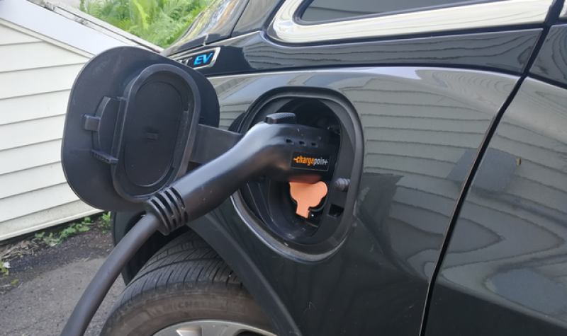 An electric vehicle plugged into a charging station.
