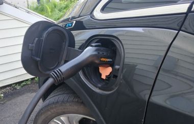 An EV charger plugged into an electric vehicle