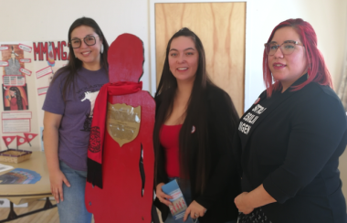 Keeshia Bernard, Katelyn Nash, and Torey Solomon, students in the Mi’kmaq Maliseet Bachelor of Social Work program which meets in Sackville. The group stands with a silhouette of Rowena Mae Sharpe who was killed in 2012. Photo: Erica Butler