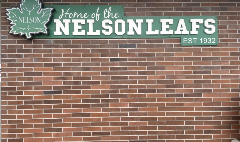 Brick wall with Home of the Nelson Leafs sign.
