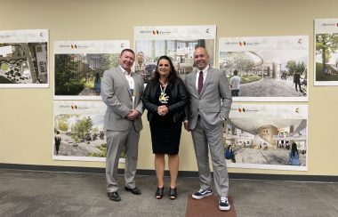 All three members, MP Jaime Battiste, Pamela Glode-Desrochers and Andy Filmore are standing and smiling for a photo behind their graphics.