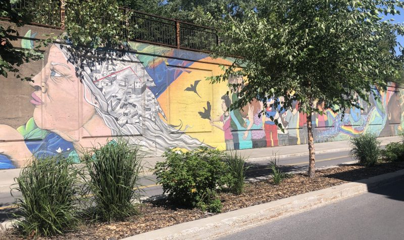 A partial view of a mural showing the history of Pointe-Saint-Charles.