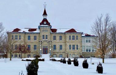 The outside of the Wellington County Museum and Archives building on a snowy, cloudy day