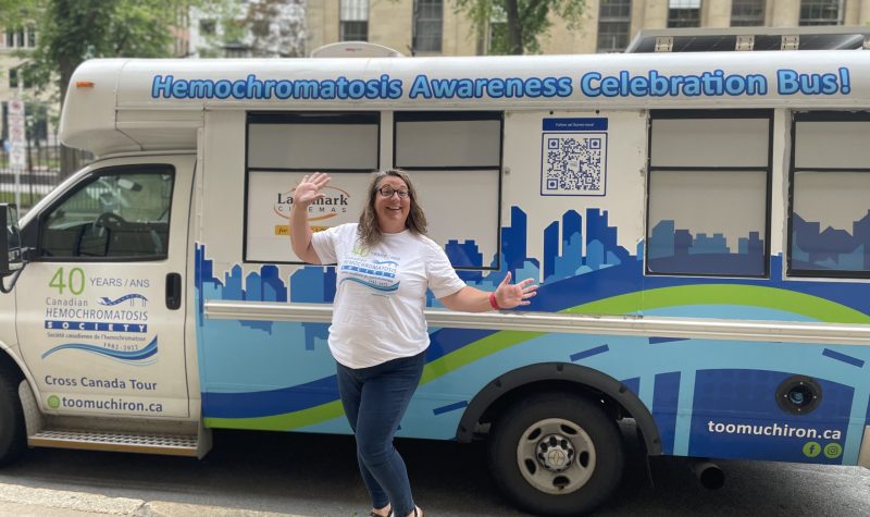 Photo of Liz Charyna, standing in front of her customized Elsie The Bus to raise awareness on hemochromatosis.