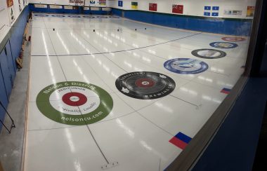 Angular shot of a curling rink. Shows six targets.