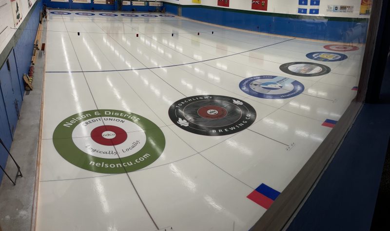 Angular shot of a curling rink. Shows six targets.