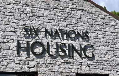 Exterior of the Six Nations Housing building grey brick with black lettering.