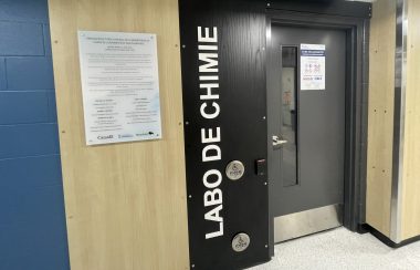 L'Université de Saint-Boniface a inauguré son nouveau laboratoire d'enseignement et de recherche en chimie. À gauche, un panneau indique tous les donateurs pour ce projet et à droite, en caractères gras et blancs, on peut lire « Labo de chimie ».