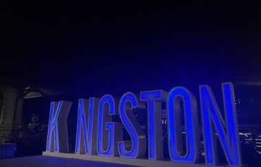 Letters reading KINGSTON in downtown Kingston, the letters are illuminated with blue light.
