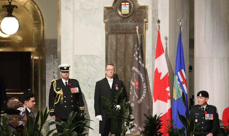 The three flags stood in the Alberta Legislature rotunda during the Legislative Assembly of Alberta's Indigenous Veterans Day ceremony. The three flags, from left to right, are; the Aboriginal Veterans Society of Alberta flag, the Canadian flag, and the Alberta flag. Photo was taken inside.