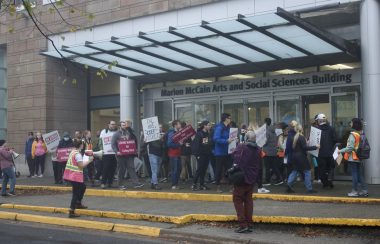 A group of 30 Dalhousie CUPE3912 union members picketing in front of Dalhousie's Marion McCain Arts and Social Sciences Building.