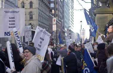 About 100 people holding signs that say same work equals same pay. They are holding signs with NSGEU, in a strike infront of the legislature in Halifax one week ago.