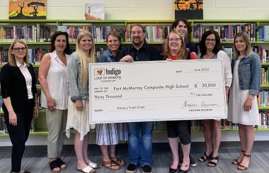 Image shows Fort McMurray Composite High School holding literacy grant from Indigo worth 30,000 dollars