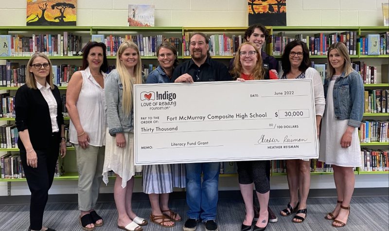 Image shows Fort McMurray Composite High School holding literacy grant from Indigo worth 30,000 dollars