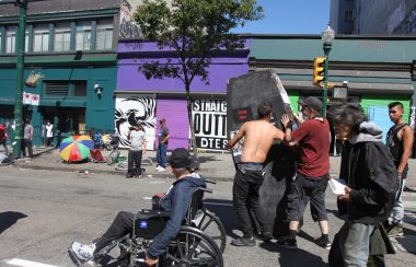Advocates for harm reduction carry a fake coffin representing the Drug War in front of Insite, Vancouver's first safe injection site