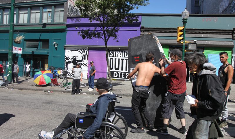 Advocates for harm reduction carry a fake coffin representing the Drug War in front of Insite, Vancouver's first safe injection site