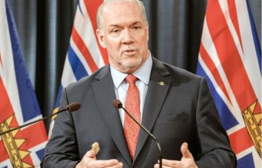 A photo of BC Premier John Horgan speaking at a press conference.
