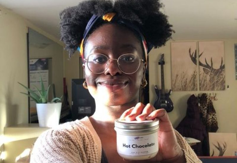 Junique Gooden holding her hot chocolate inspired body butter.
