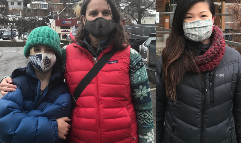 Three people outside wearing masks