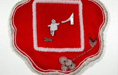 A piece of red fabric with traditional Mohawk beadwork is seen with a cutout from a black-and-white family photo in the center.