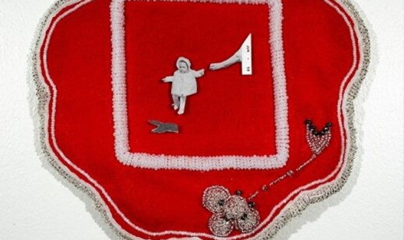 A piece of red fabric with traditional Mohawk beadwork is seen with a cutout from a black-and-white family photo in the center.