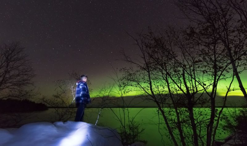 Image shows boy gazing at the northern light (Photo Credits - Louis Iron