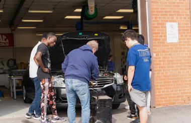 A group of people working on a car