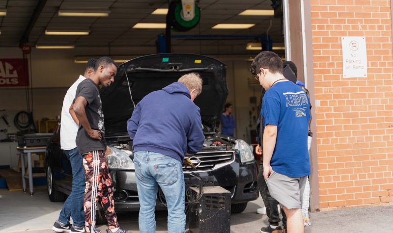 A group of people working on a car