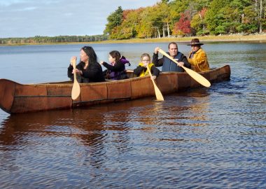 Three generations of the Labrador family paddle the newly finished canoe