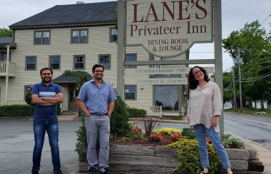 Manager Milan Virani, New Owner Ankur Viirani and Susan Lane stand outside Lane's Privateer Inn