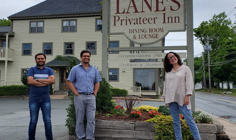 Manager Milan Virani, New Owner Ankur Viirani and Susan Lane stand outside Lane's Privateer Inn