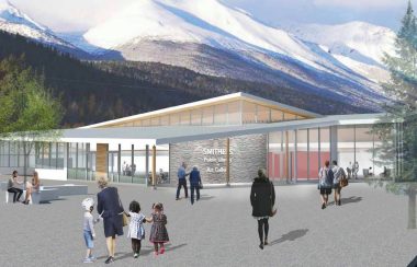 A concept design photo shows the proposed building in smithers that will be the town library and art gallery. People are walking into the building with a large mountain behind the building.