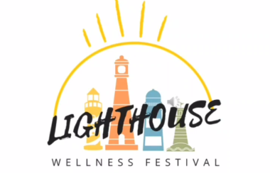 Lighthouse Wellness Logo features multicoloured lighthouses and a sun shining with multiple rays in the middle.